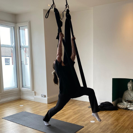 Burn survivor at ariel yoga session